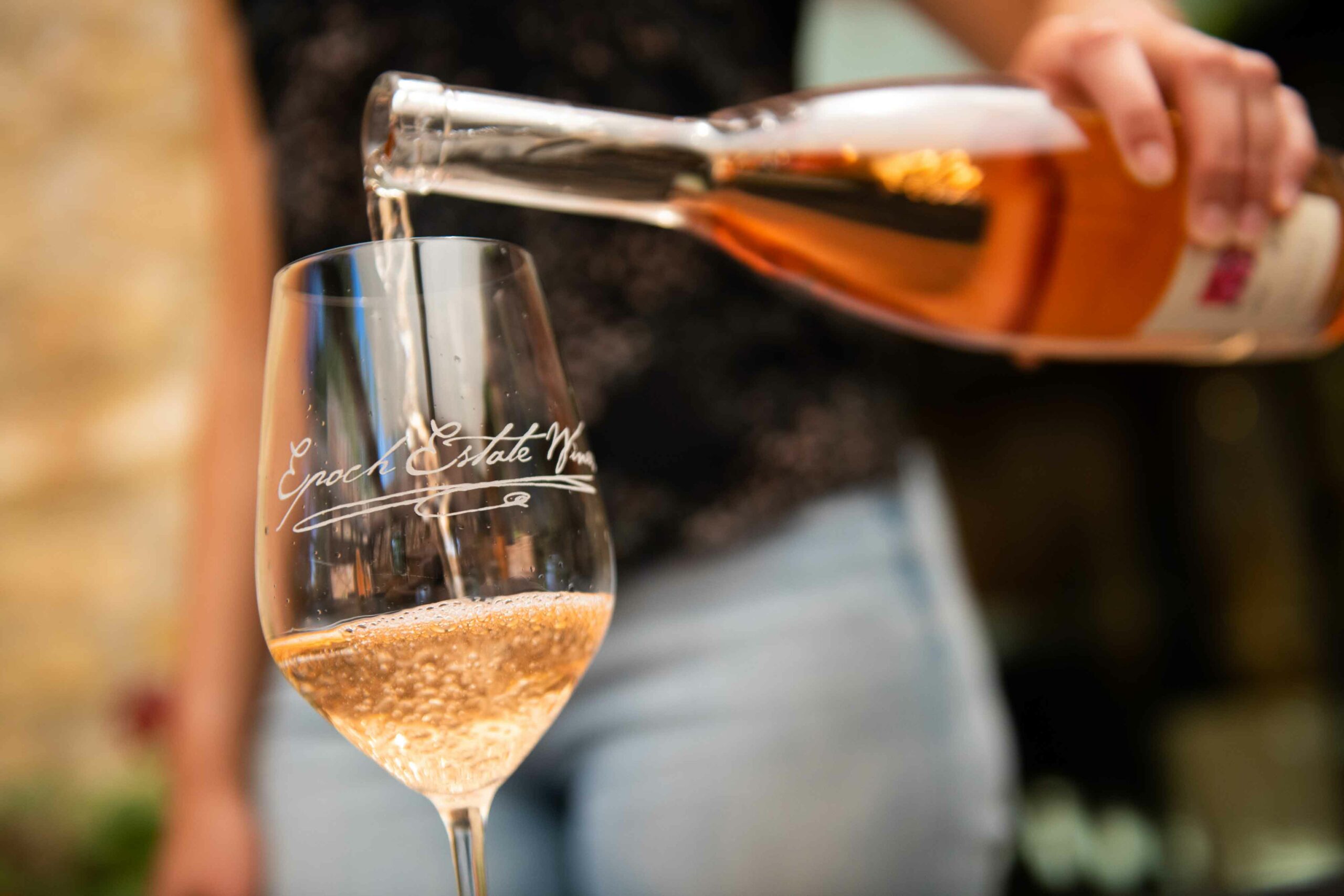 Bottle of Rosé being poured into an Epoch Estate Wines branded glass